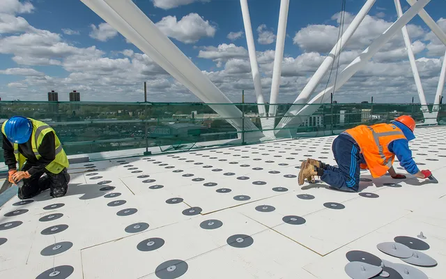 Operatives on a large roof during installation and inspection works