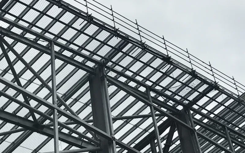 Perimeter edge protection and safety netting on a steel-frame roof structure